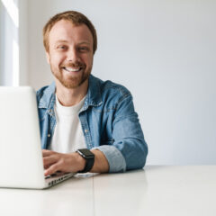 Robert smiling laptop while working with aivie